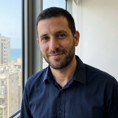 Generated LinkedIn profile photo of the same man in a navy shirt by an office window.